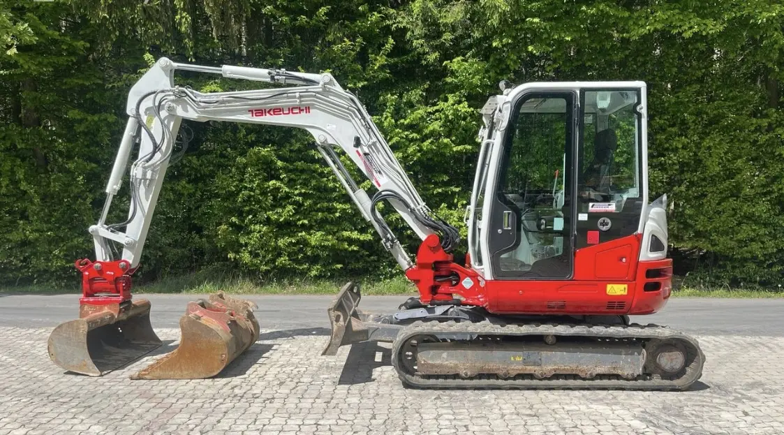 Compact excavator with multiple attachments