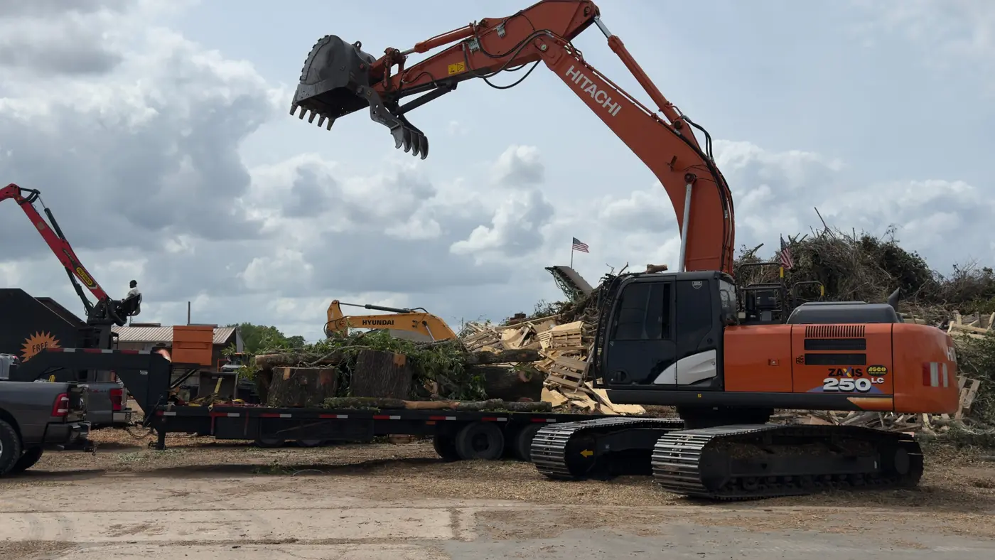 Heavy excavator and hauling equipment staged for work